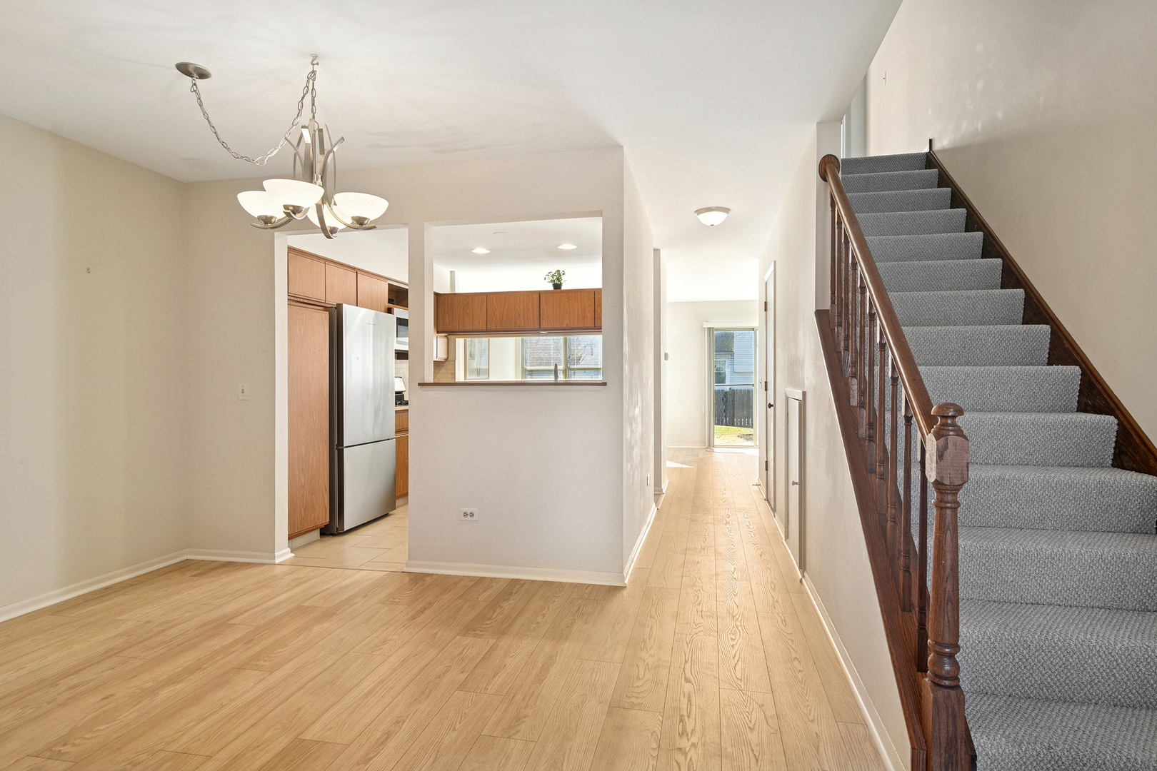 988 Ridgefield Lane Wheeling, IL 60090 - Photo 2 of 18 a view of a kitchen with wooden floor and staircase