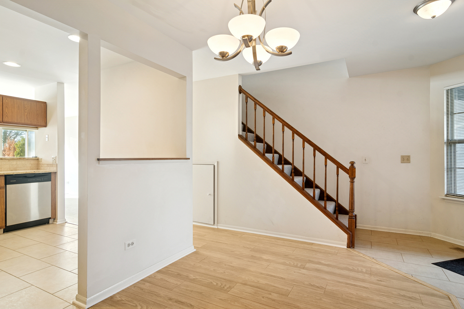 988 Ridgefield Lane Wheeling, IL 60090 - Photo 4 of 18 a view of a hallway with wooden floor and staircase