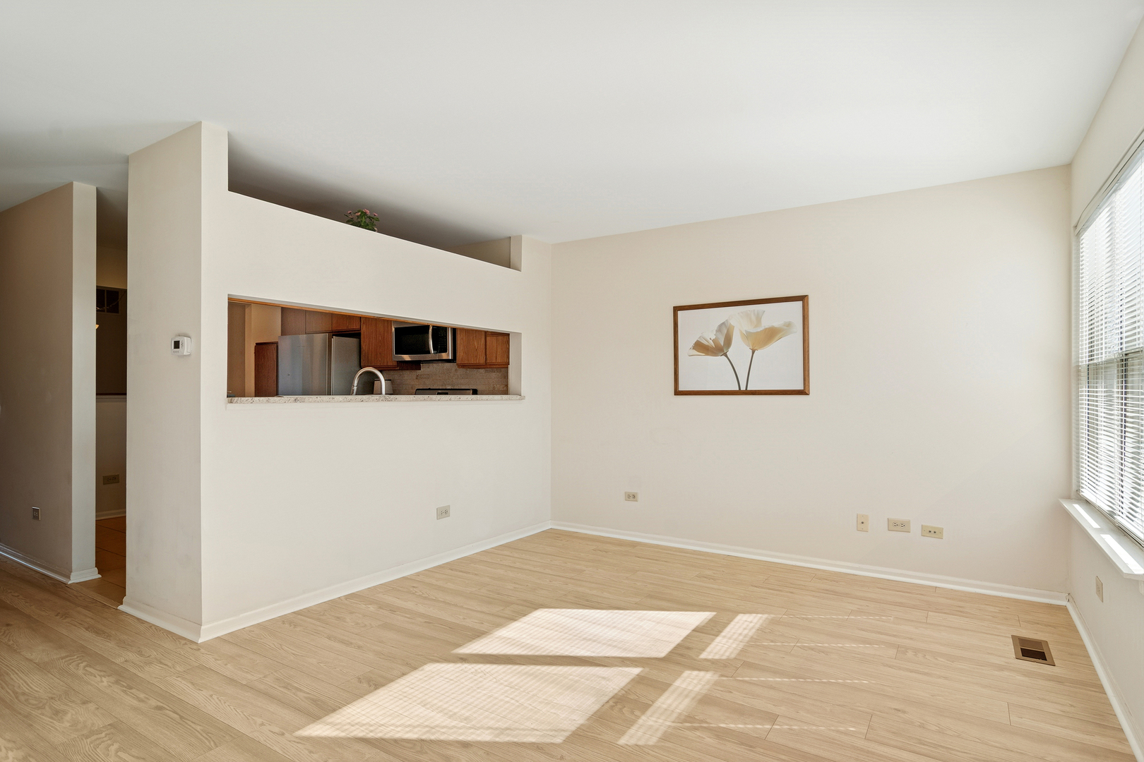 988 Ridgefield Lane Wheeling, IL 60090 - Photo 9 of 18 a view of a big room with wooden floor and windows