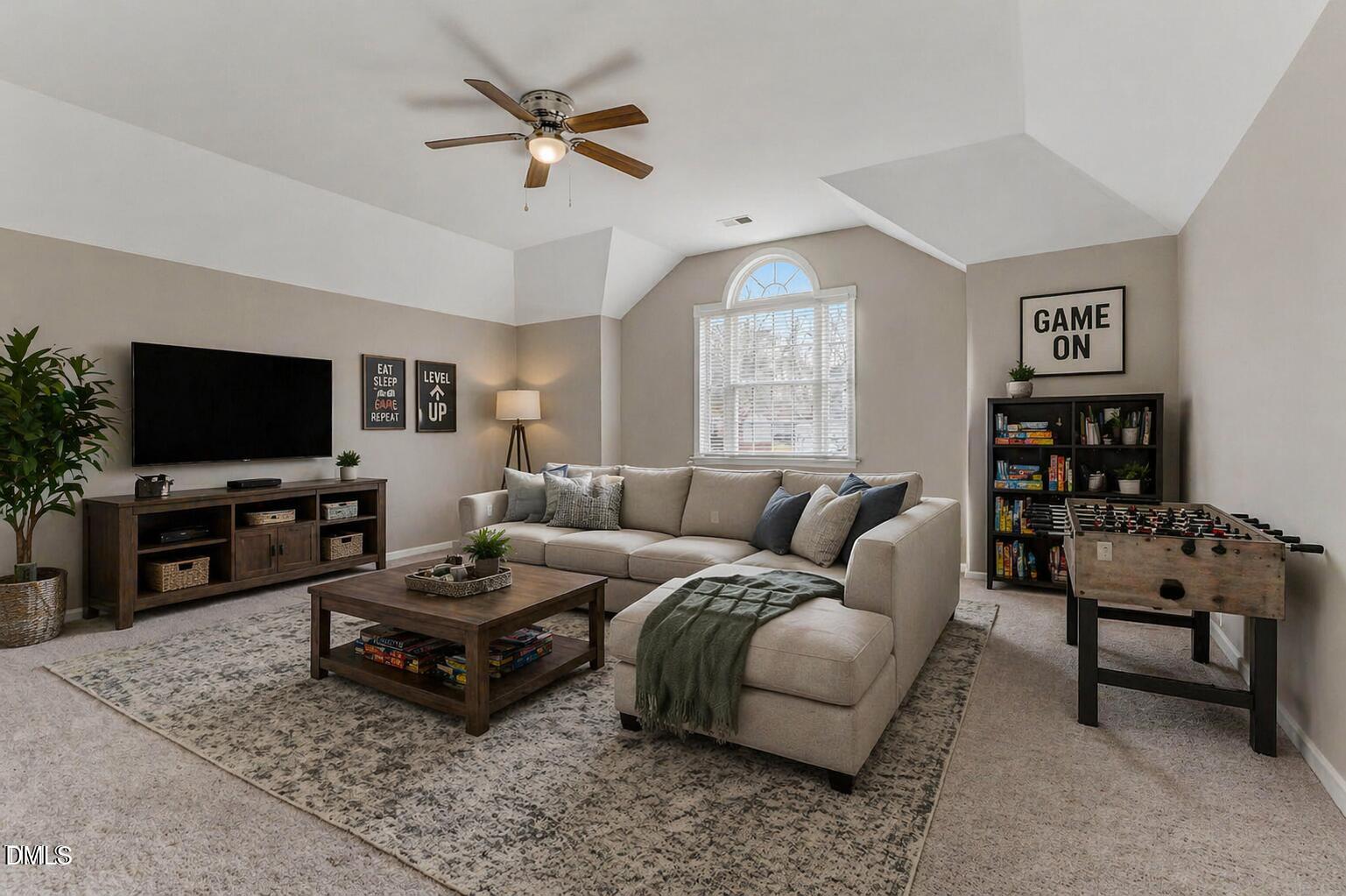 480 Seastone Street Raleigh, NC 27603 - Photo 4 of 26 a living room with furniture a flat screen tv and a window