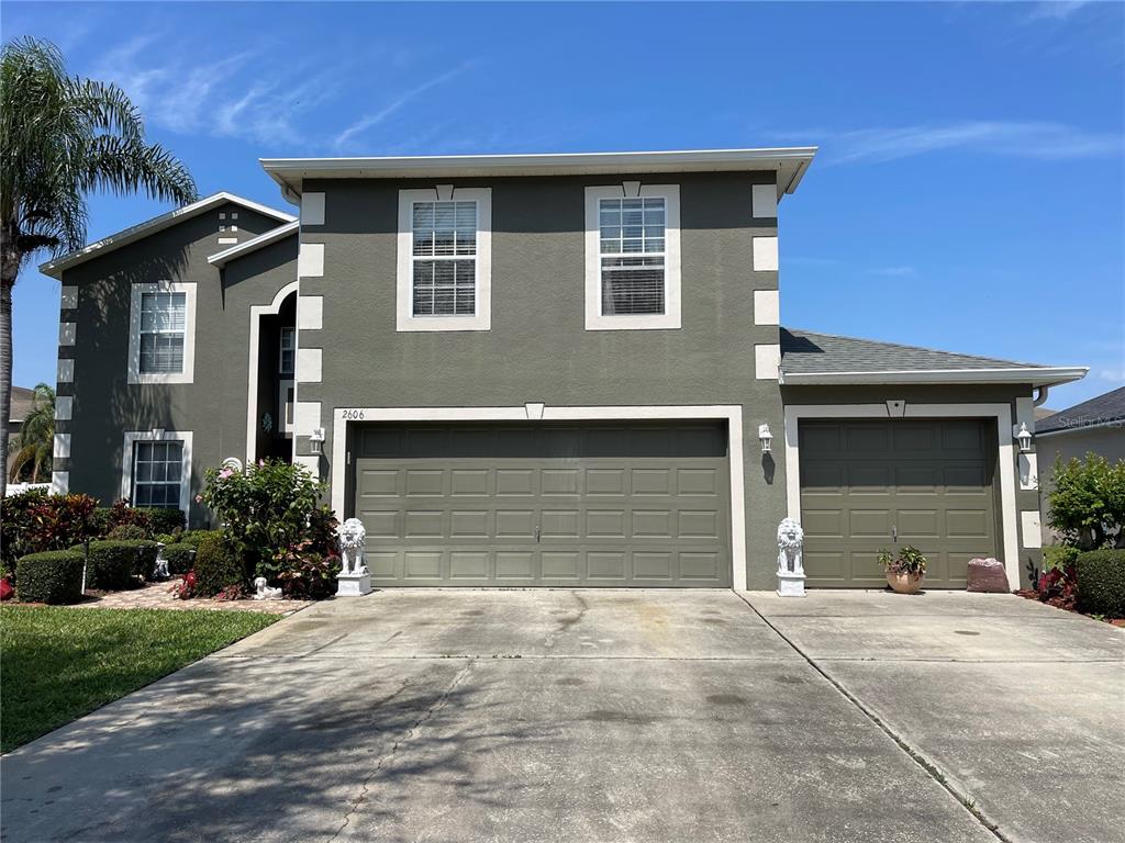 2606 Judge Loop, Unit EFFICIENCY Kissimmee, FL 34743 - Photo 1 of 1 a front view of a house with a yard and garage