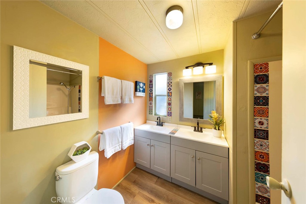 32802 Valle Road, Unit 108 San Juan Capistrano, CA 92675 - Photo 15 of 32 a bathroom with a double vanity sink mirror and toilet