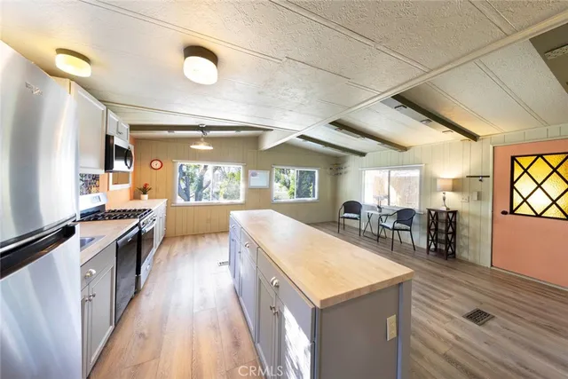 a large white kitchen with a large window