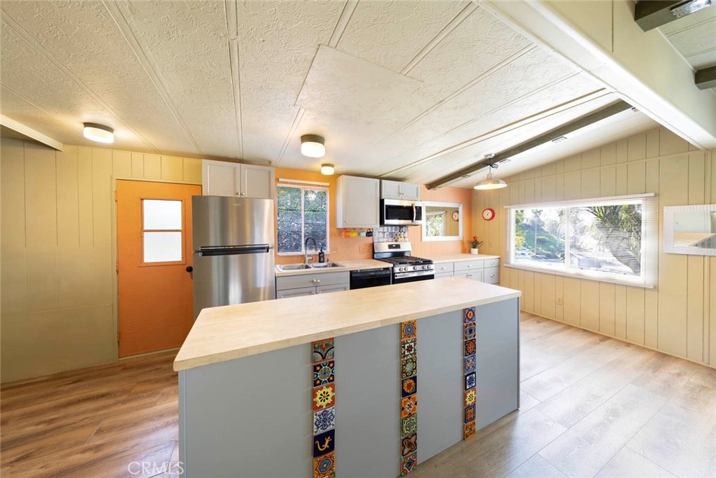 32802 Valle Road, Unit 108 San Juan Capistrano, CA 92675 - Photo 19 of 32 a large white kitchen with a large window