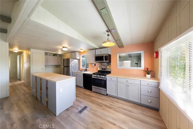 a large kitchen with lots of counter space and stainless steel appliances