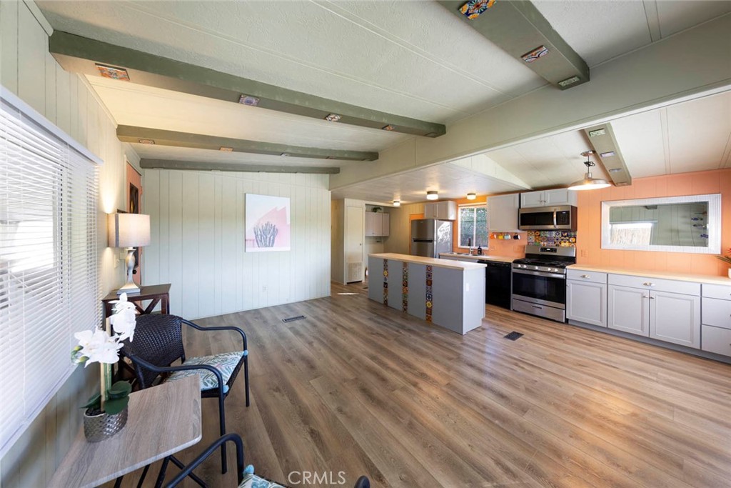 32802 Valle Road, Unit 108 San Juan Capistrano, CA 92675 - Photo 23 of 32 a open kitchen with stainless steel appliances kitchen island granite countertop a stove and a refrigerator