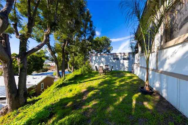 a backyard of a house with table and chairs