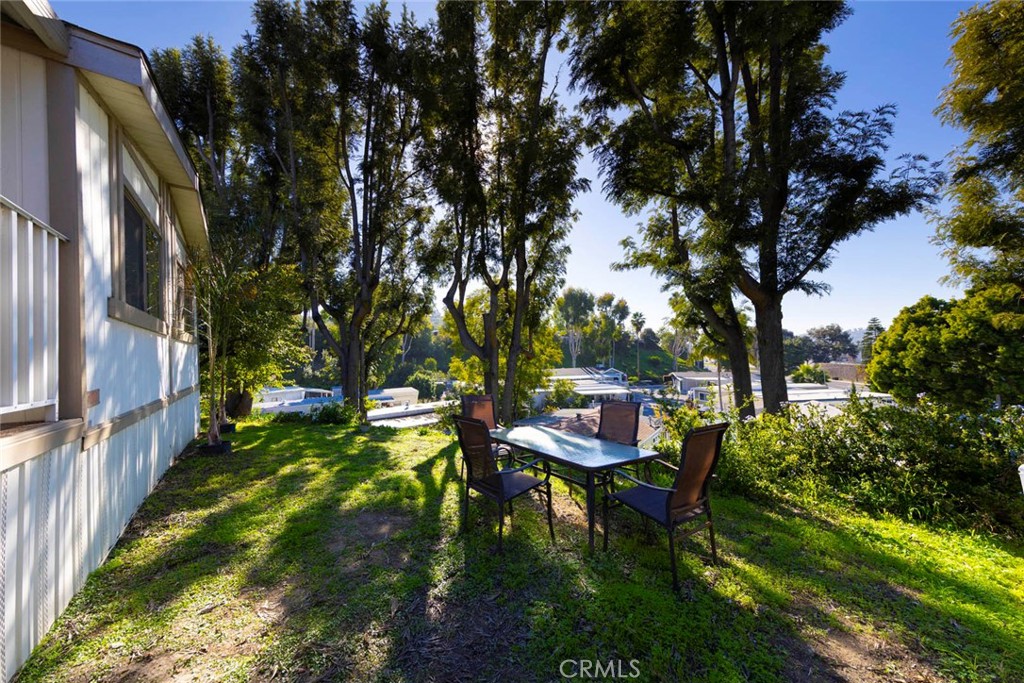 32802 Valle Road, Unit 108 San Juan Capistrano, CA 92675 - Photo 29 of 32 a backyard of a house with table and chairs