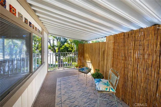 a view of a house with a trees from a balcony