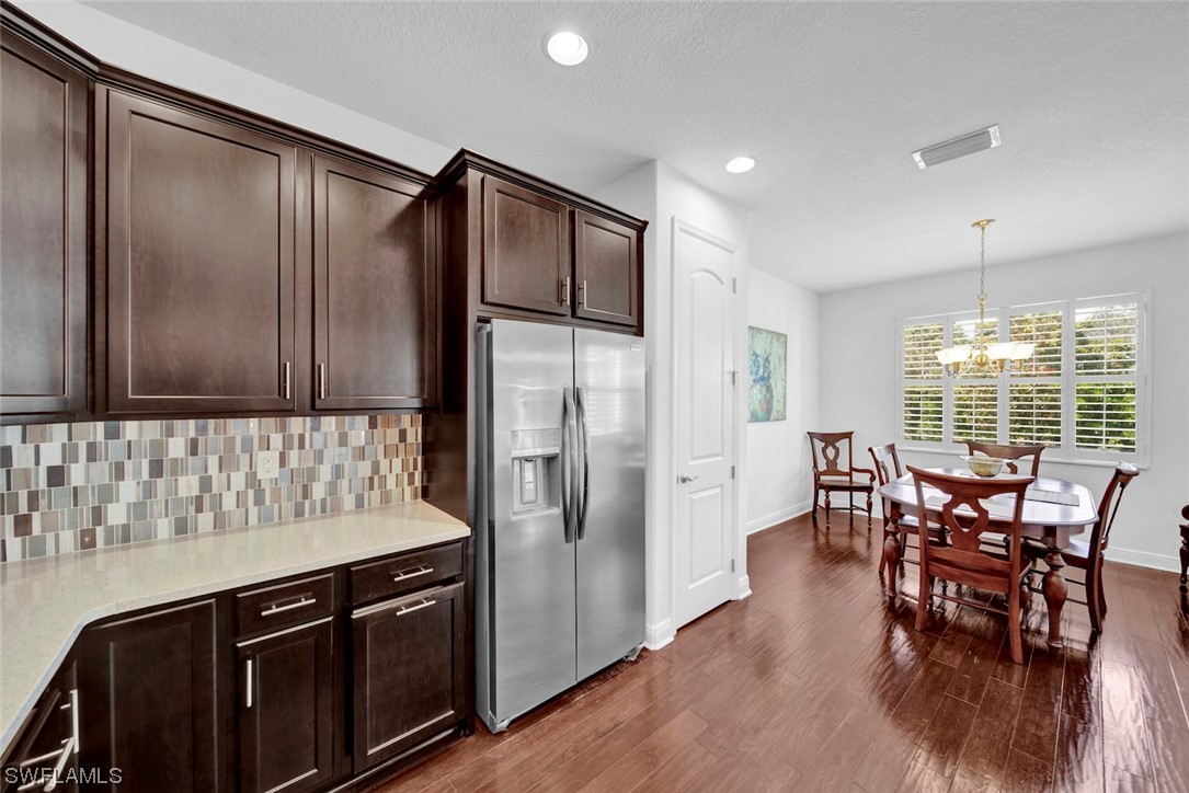 19630 Tesoro Way Estero, FL 33967 - Photo 12 of 44 a kitchen with stainless steel appliances granite countertop a stove and a refrigerator