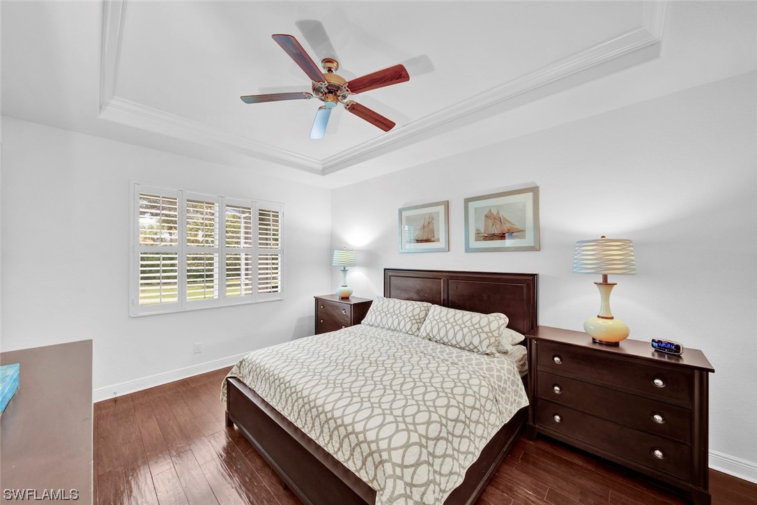 19630 Tesoro Way Estero, FL 33967 - Photo 13 of 44 a bedroom with a bed and a chandelier