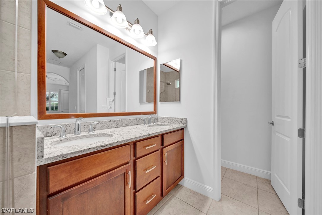 19630 Tesoro Way Estero, FL 33967 - Photo 19 of 44 a bathroom with a sink and a mirror