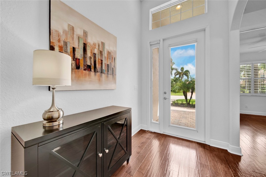 19630 Tesoro Way Estero, FL 33967 - Photo 2 of 44 a view of entryway and hall with wooden floor