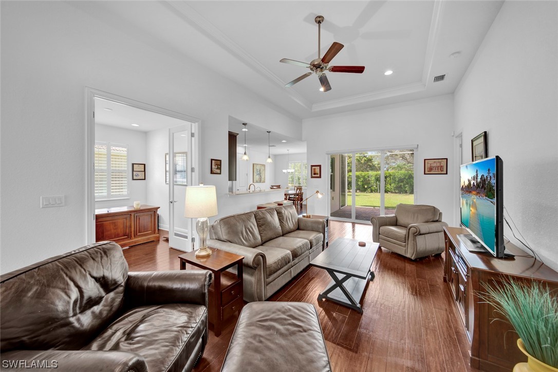 19630 Tesoro Way Estero, FL 33967 - Photo 21 of 44 a living room with furniture wooden floor and a large window