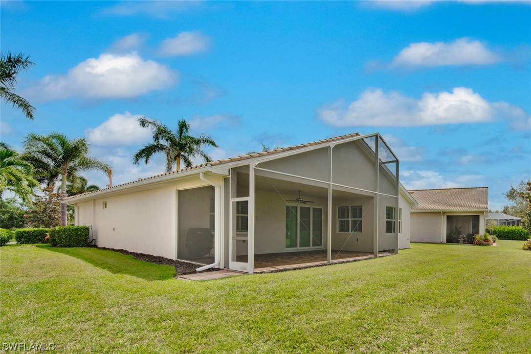 19630 Tesoro Way Estero, FL 33967 - Photo 27 of 44 a front view of a house with a yard and garage