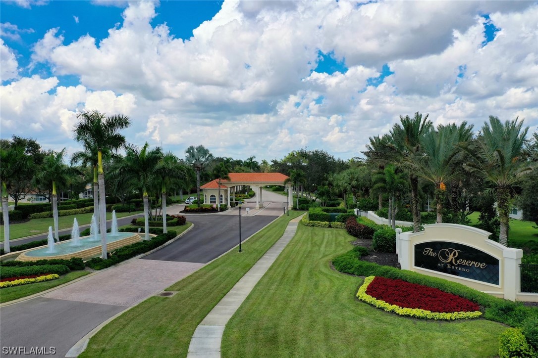 19630 Tesoro Way Estero, FL 33967 - Photo 31 of 44 a front view of a house with garden
