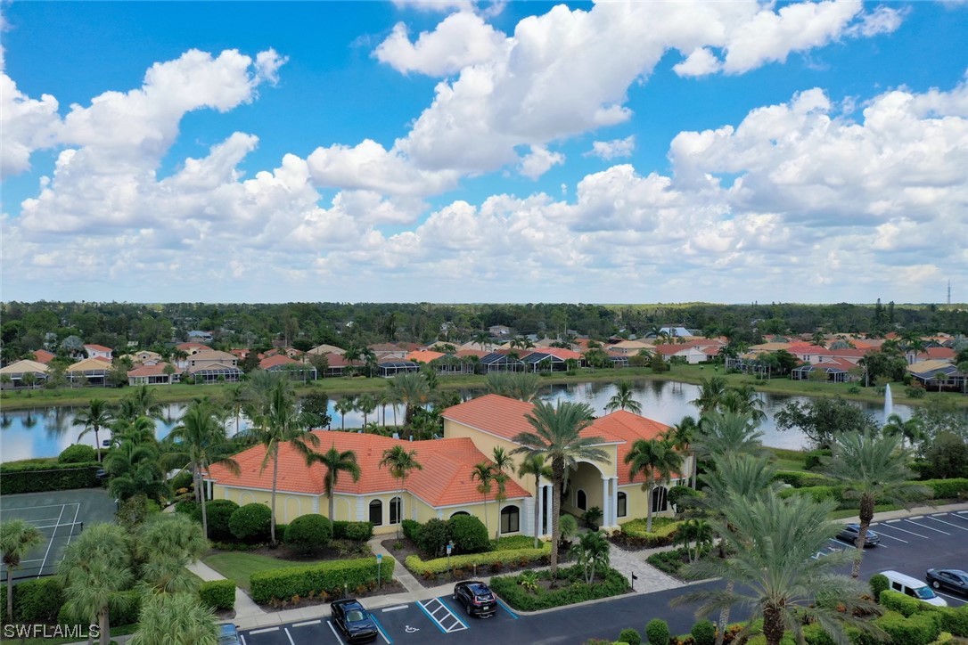19630 Tesoro Way Estero, FL 33967 - Photo 32 of 44 an aerial view of lake residential house with green space and car parked