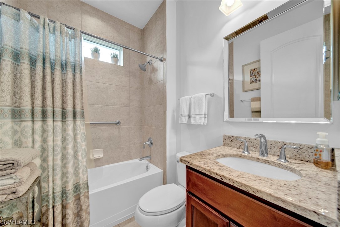 19630 Tesoro Way Estero, FL 33967 - Photo 8 of 44 a bathroom with a granite countertop sink toilet and shower