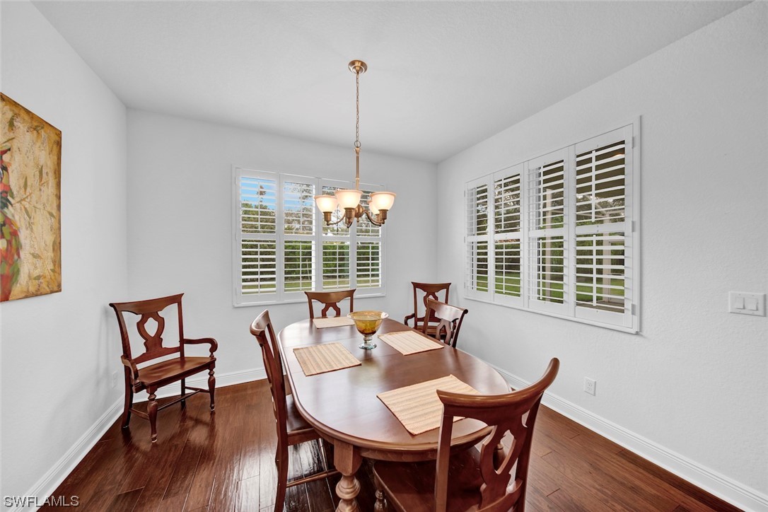 19630 Tesoro Way Estero, FL 33967 - Photo 9 of 44 a dining room with furniture a chandelier and wooden floor