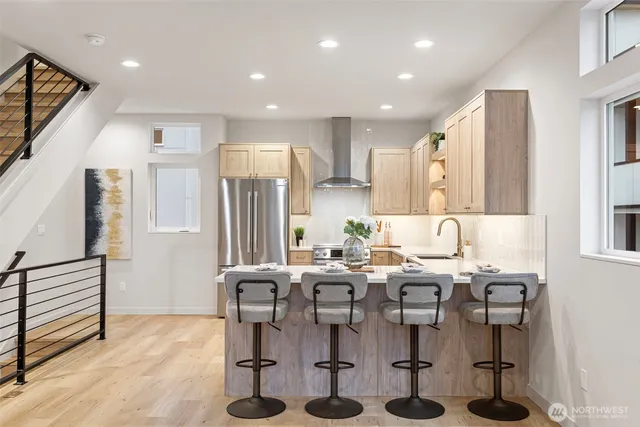 a kitchen with stainless steel appliances kitchen island granite countertop a refrigerator and cabinets