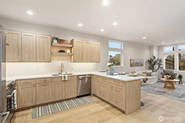 a kitchen with sink stove and cabinets
