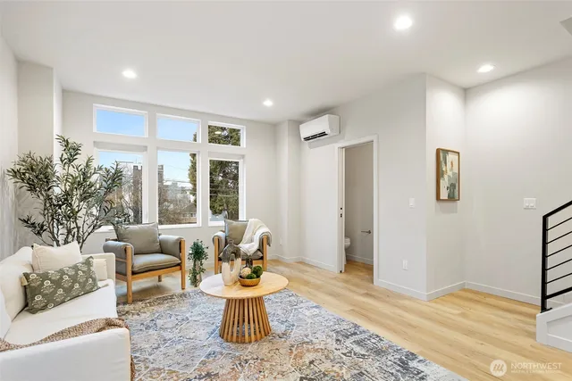 a living room with furniture and a potted plant