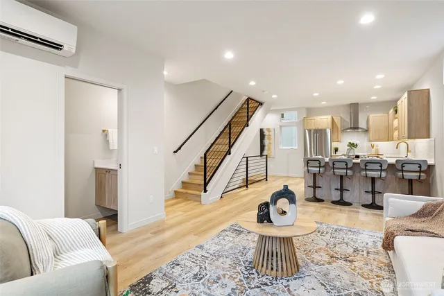 a living room with furniture and kitchen view