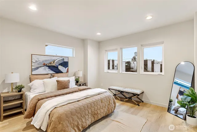 a bedroom with a bed a mirror and desk