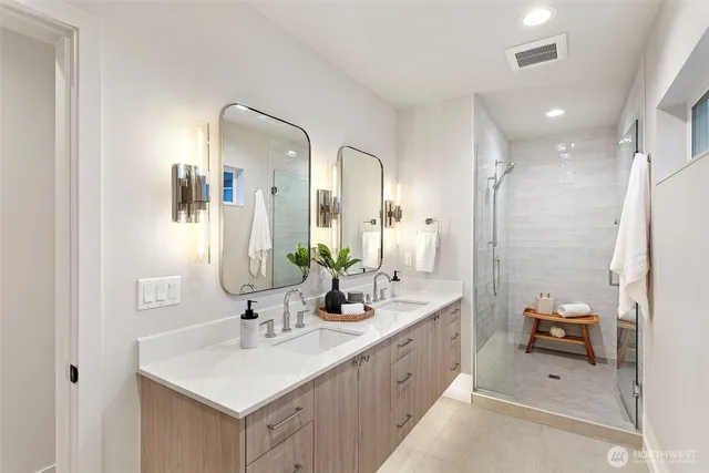 a bathroom with a double vanity sink mirror and