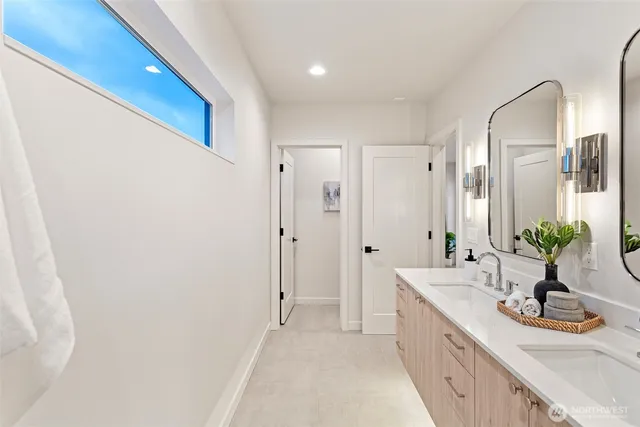 a spacious bathroom with a double vanity sink and a mirror