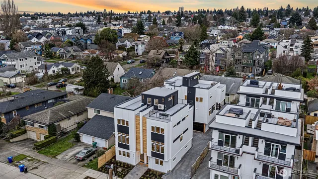 an aerial view of a residential apartment building with a yard