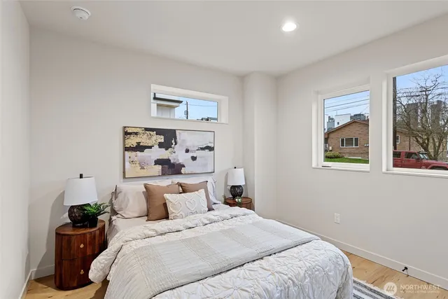 a bedroom with bed and wall painting