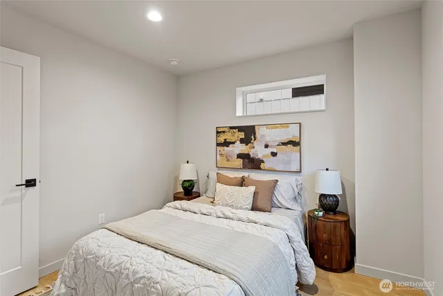 a bedroom with a bed and wall painting