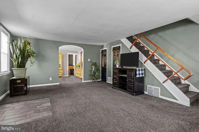 a view of a livingroom with furniture and a flat screen tv