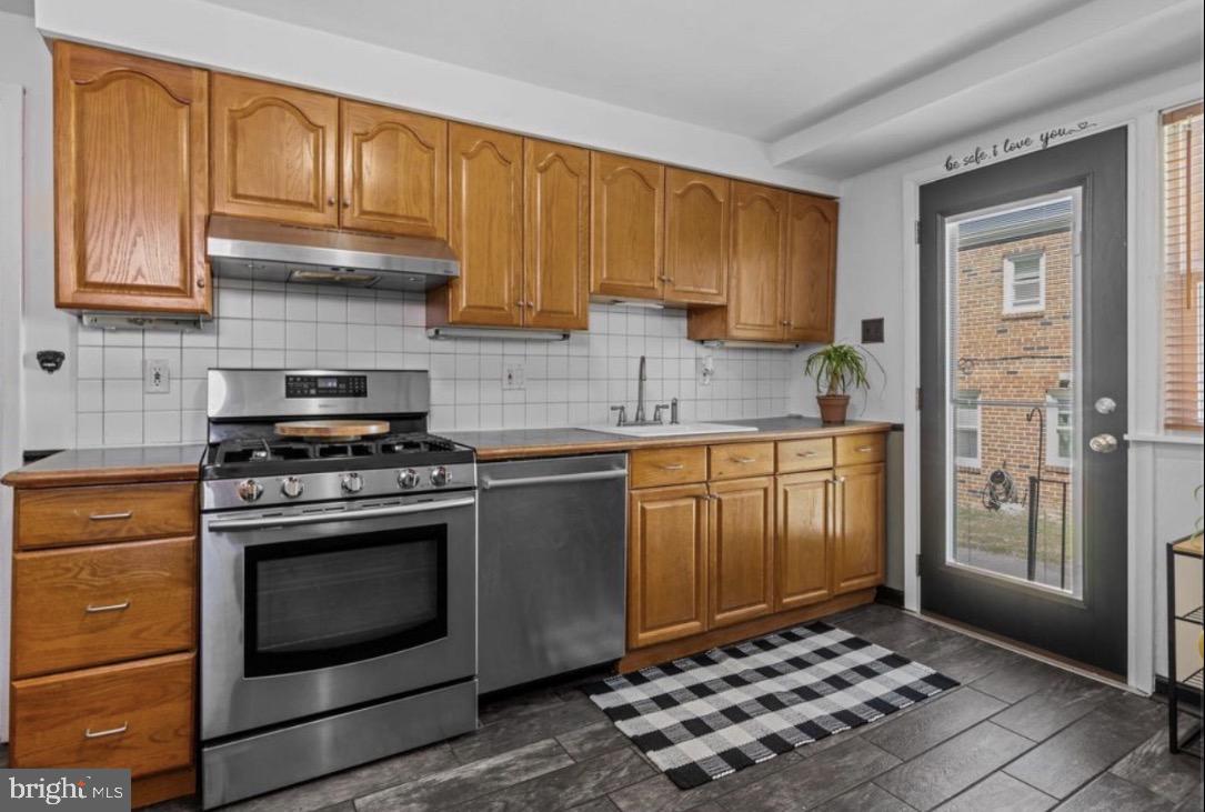 809 Millwood Road Philadelphia, PA 19115 - Photo 9 of 20 a kitchen with granite countertop wooden cabinets and stainless steel appliances