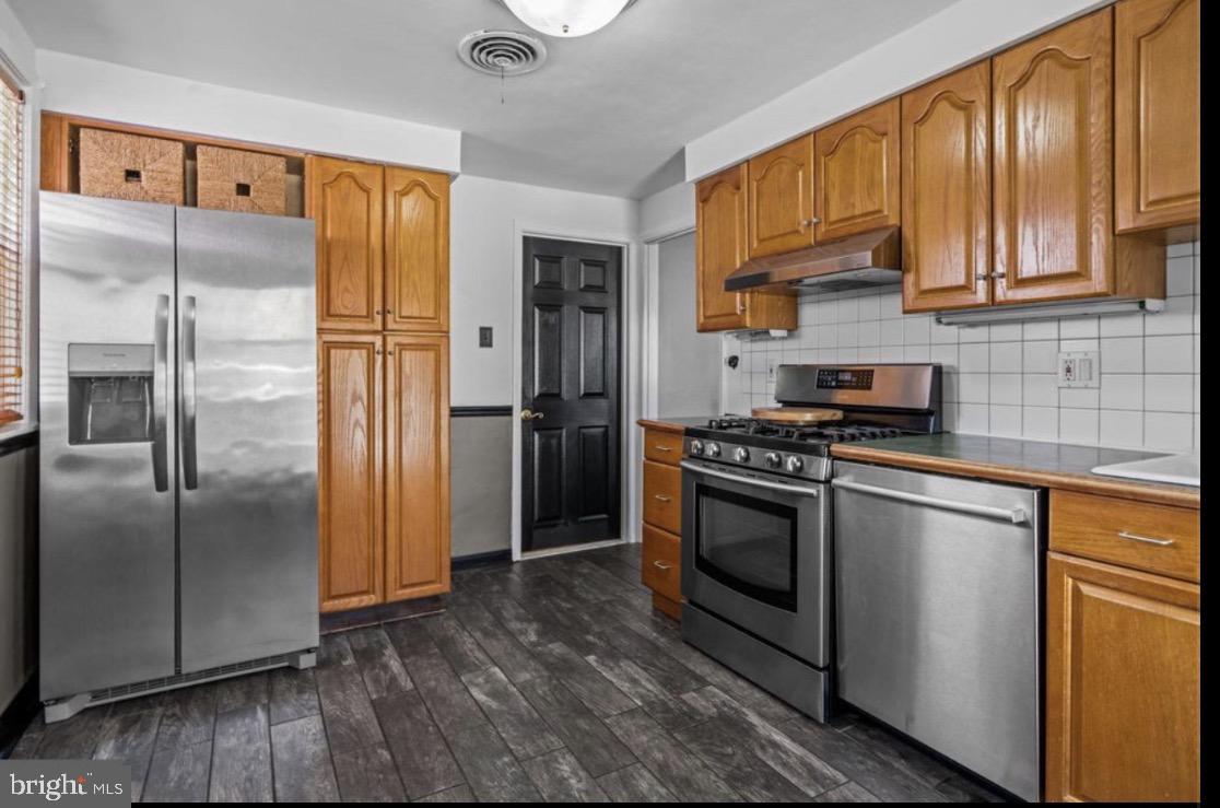 809 Millwood Road Philadelphia, PA 19115 - Photo 10 of 20 a kitchen with stainless steel appliances granite countertop a refrigerator stove and sink