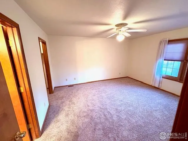 an empty room with windows and entrance