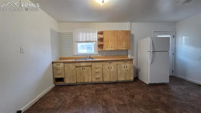 a utility room with cabinets washer and dryer