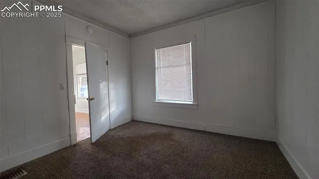 an empty room with a empty space and windows