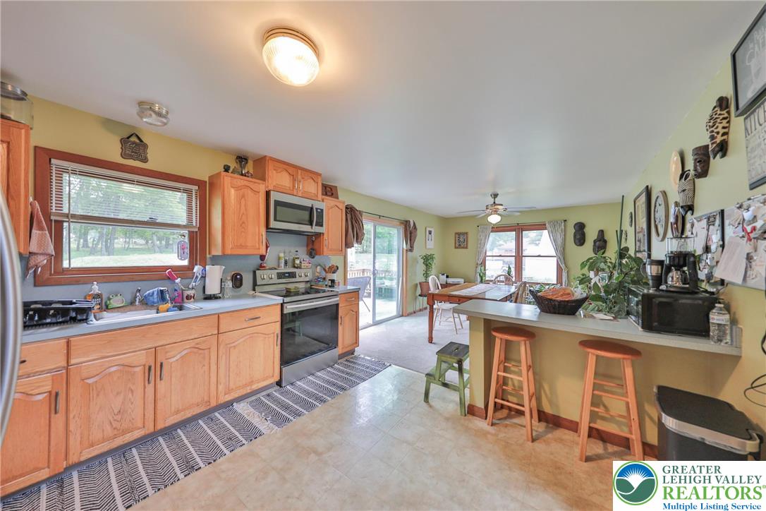 4608 Pine Ridge Drive West Bushkill, PA 18324 - Photo 20 of 62 A well-equipped kitchen offers ample cabinet space, with an adjacent dining area providing a relaxed atmosphere.