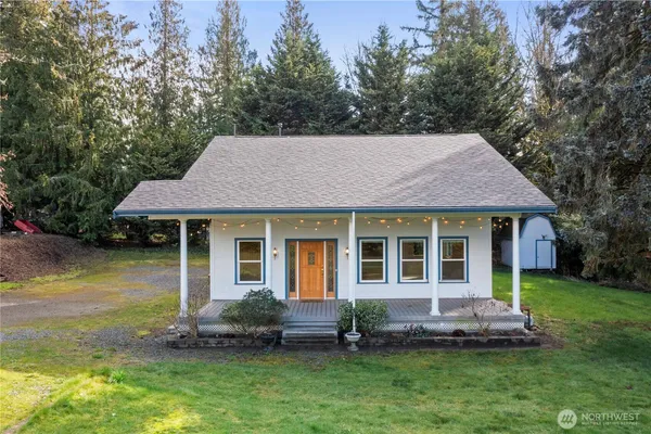 a aerial view of a house with a yard table and chairs