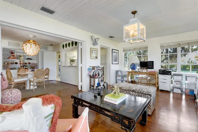 a living room with furniture a chandelier and a flat screen tv