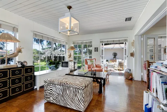 a bedroom with a bed and a flat tv screen on dresser