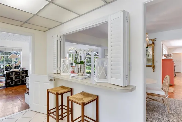 a view of a patio with couches potted plants and a big yard
