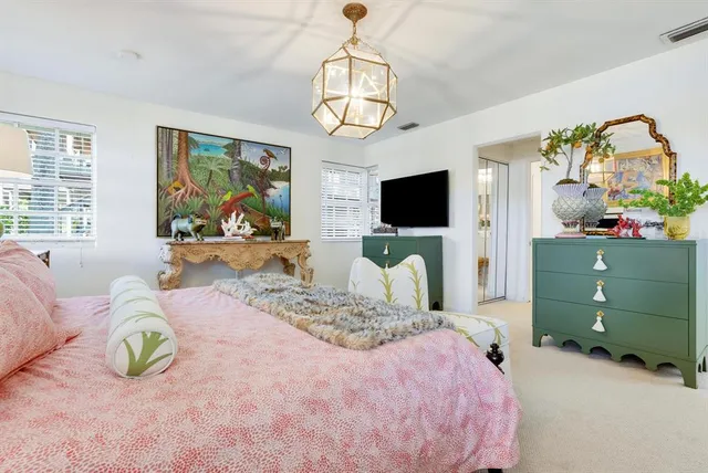a view of a patio with table and chairs and potted plants with wooden floor and lake view
