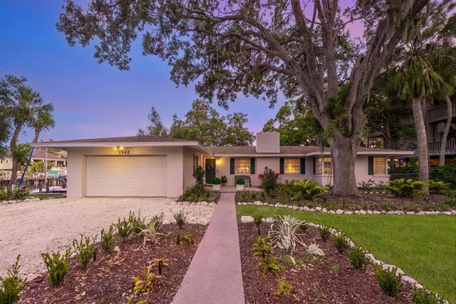 a view of a building with a patio and a yard
