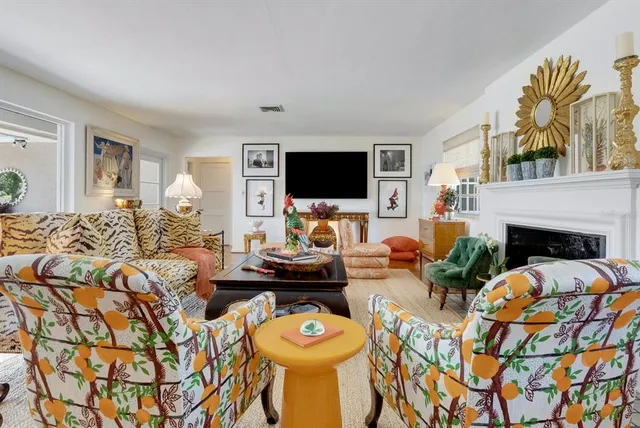 a living room with furniture and a fireplace