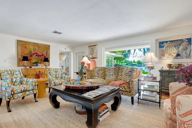 a living room with furniture and a floor to ceiling window