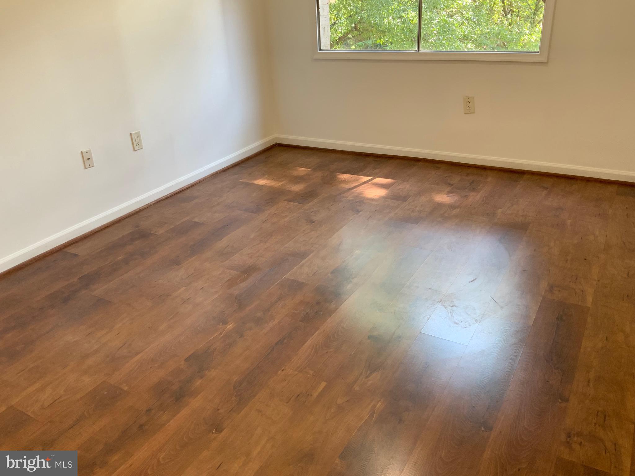 3744 Bel Pre Road, Unit 10 Silver Spring, MD 20906 - Photo 14 of 23 an empty room with wooden floor and windows