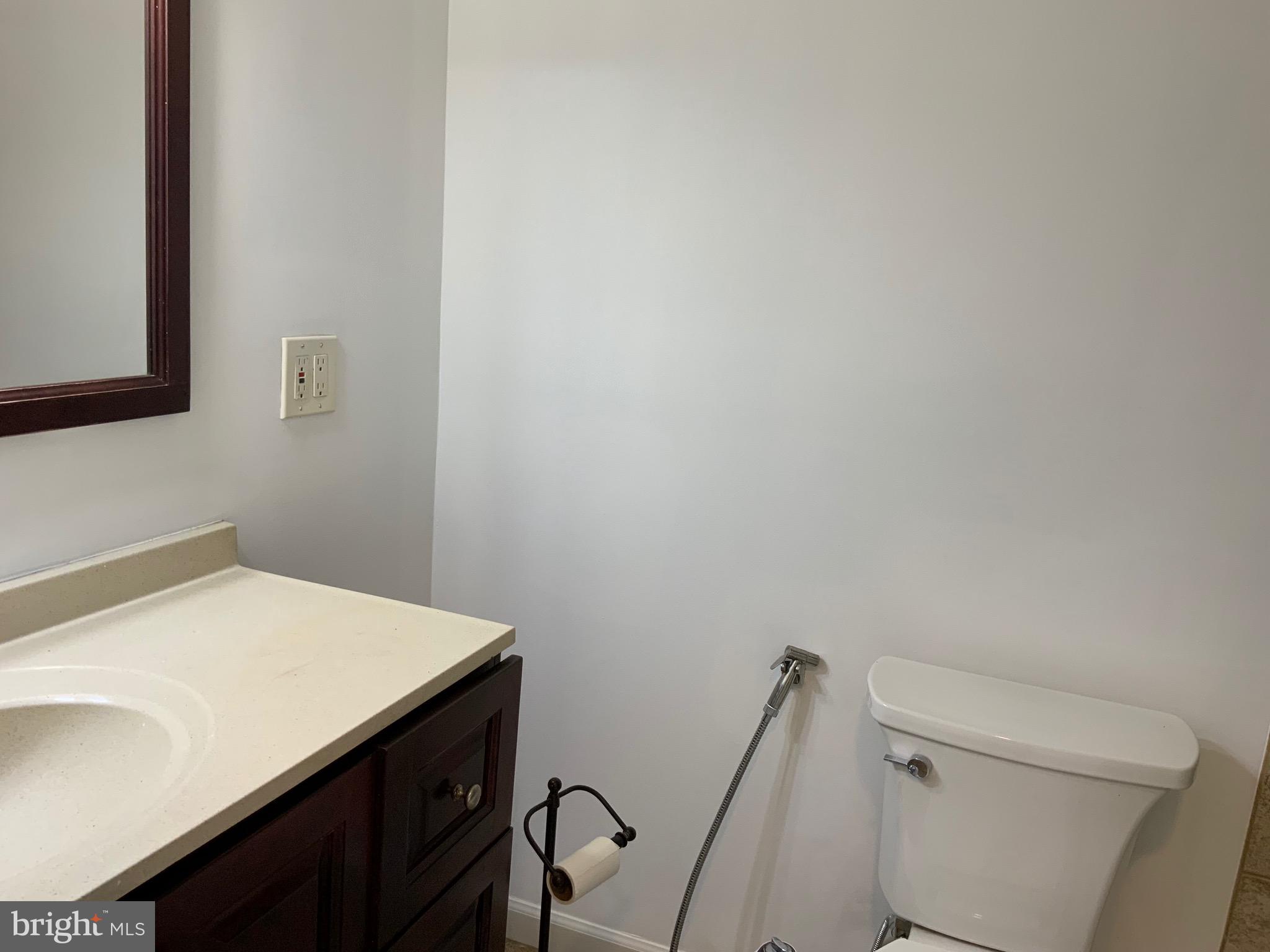 3744 Bel Pre Road, Unit 10 Silver Spring, MD 20906 - Photo 17 of 23 a bathroom with a sink a toilet and a mirror